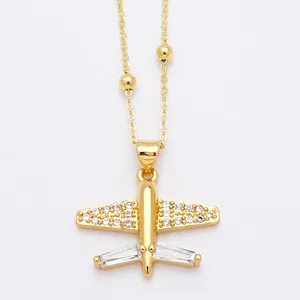 Gold airplane pendant necklace with sparkling cubic zirconia on a beaded chain