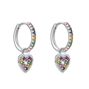 Detailed view of silver heart earrings encrusted with colorful rainbow cubic zirconia