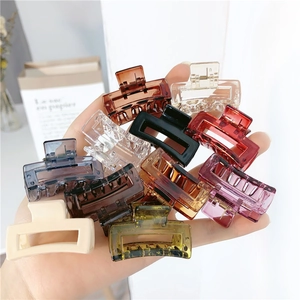 Close-up of assorted medium square hair claws in multiple colors including amber and purple