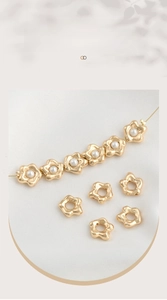 Close-up of 14K gold-filled flower beads with pearl center for jewelry making