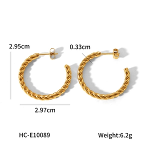 Detailed view of golden twist hoop earrings with 2.95cm diameter and 6.2g weight specs