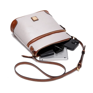 Detail view of pebbled leather crossbody bag showing spacious interior with daily essentials
