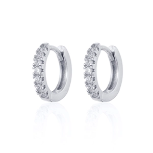 Detailed macro view of silver earrings featuring white zircon inlay with subtle reflections