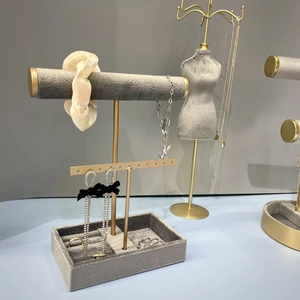 Grey velvet jewelry display stand set with gold metal frames for necklaces and earrings