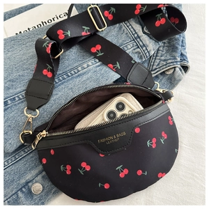 Detail view of the black cherry print crossbody bag showing interior phone storage space