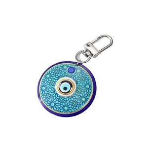 Bohemian tribal keychain with large blue evil eye round pendant on white background