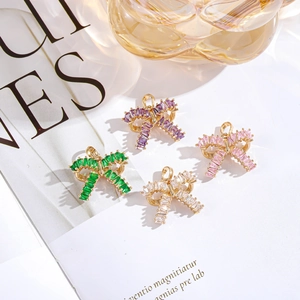 Bow-shaped gold pendants with colorful cubic zirconia crystals in four vibrant colors