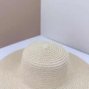 Primo piano della trama intrecciata di un cappello di paglia beige per il sole.