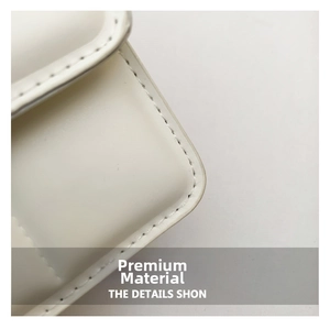 Detailed close-up showing precision stitching and smooth leather texture of a white handbag