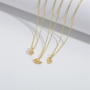 Gold snail, cross and slipper pendant necklaces for women on a white background