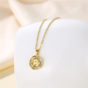 Macro view of 18K gold plated necklace with round letter P pendant and baguette zircons