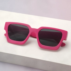 Detail of trendy rose pink rectangular thick frame sunglasses with dark grey lenses