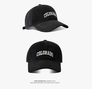 Detail view of black cotton baseball cap with white Colorado embroidery and metal buckle