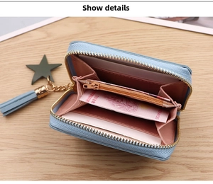 Detail view of the sky blue accordion coin purse with pink interior and gold hardware