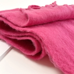 Close-up of soft pink mohair scarf showing fluffy texture and premium wool fibers