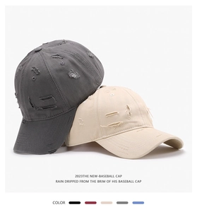 Detailed view of distressed baseball caps featuring vintage frayed edges and cotton texture