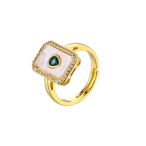 Detail of 18K gold ring featuring green heart gemstone and white mother of pearl inlay