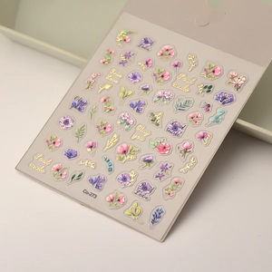 Macro view of embossed floral nail art stickers with gold outlines and Soul Mate text