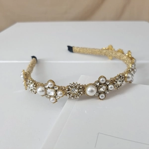 Detail of baroque pearl and crystal headband with gold wire weaving and soft padding
