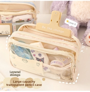Detailed view of the layered storage compartments in this large clear canvas pencil case