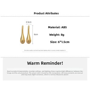 Detailed view of large gold teardrop earrings with dimensions of 6cm height and 1.5cm width