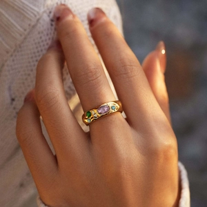 Vintage gold wide ring with purple and green zircons on a textured stainless steel band