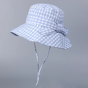 Detail of blue gingham sun hat showing bow decoration and adjustable windproof strap