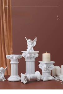 Detail of vintage Nordic Roman column with small winged angel sculpture home decor