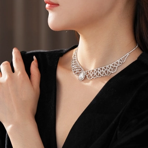 Close-up of model wearing silver teardrop rhinestone necklace with elegant lace details