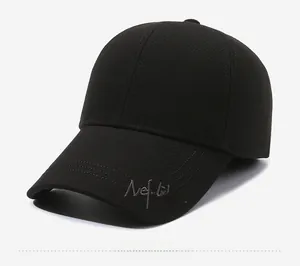 Detail view of Nefelibata embroidery on black wool baseball cap with side profile