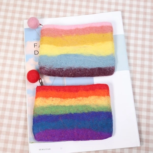 Rainbow striped handmade wool felt coin purse with a colorful pom-pom zipper puller