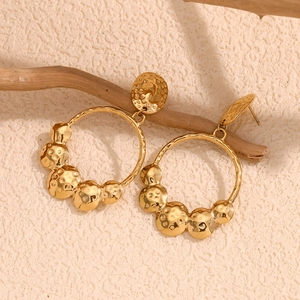Chic 18K gold plated stainless steel hammered disc drop earrings on a dry wooden branch