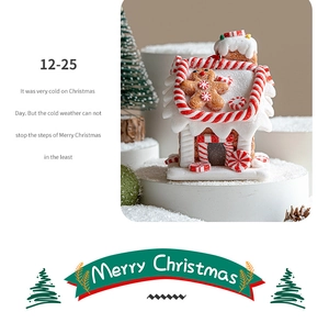 Exquisite gingerbread house decoration with faux snow roof and candy cane detailing