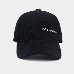 Close-up of Mama embroidery on black corduroy baseball cap with fine ribbed texture