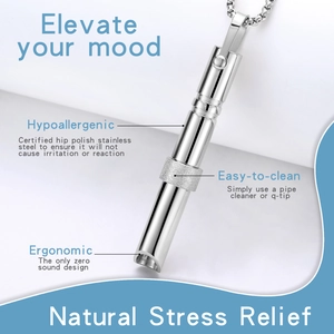 Close-up of silver meditation whistle showing ergonomic hypoallergenic stainless steel details
