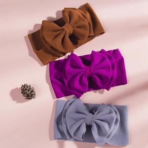 Detailed waffle knit texture of oversized baby bow headbands in assorted colors