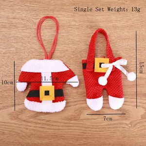 Mini Santa suit cutlery holders with weight tag on a brown wooden texture background
