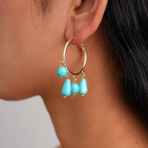 Bohemian gold ring earrings with turquoise stone tassels worn by model for elegant style