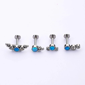 316L stainless steel piercing set with blue opal and clear zircon on a plain white background