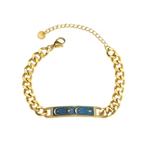 Detail of gold Cuban link bracelet with celestial blue plate featuring sun and moon