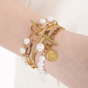 Layered gold snake chain and pearl bracelet set with OT toggle and sailboat pendant