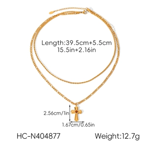 Detailed view of layered gold cross necklace with dimension and weight markings
