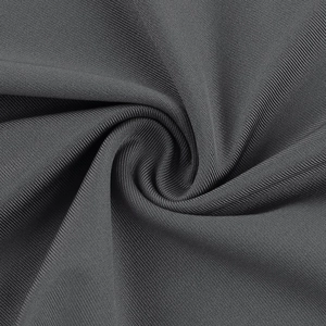 Macro shot of dark grey knit fabric texture showing high elasticity and soft ribbed weave