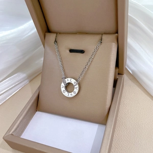 Titanium steel LOVE ring necklace with diamond inlay in a beige jewelry box