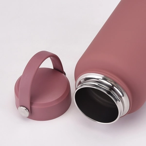 Detail of wide-mouth stainless steel water bottle with matte pink finish and handle lid
