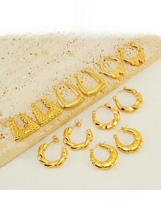 Detailed set of 6 pairs of gold-plated titanium earrings with textured twist and bow designs