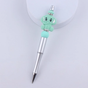 Detail of silver beaded pen with green elephant cartoon topper and sparkling rhinestones