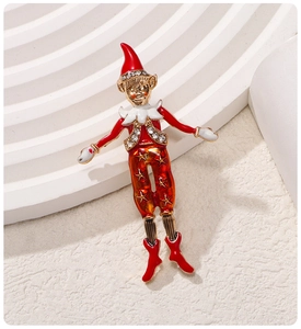 Detailed view of an enamel Christmas elf brooch with red hat and sparkling rhinestones