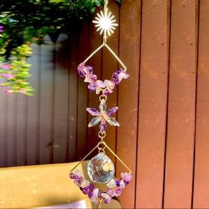 Golden suncatcher with amethyst stones and faceted crystal ball reflecting light