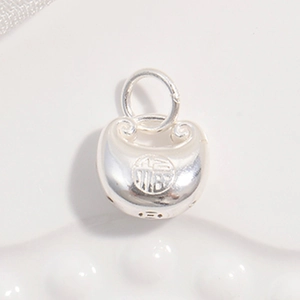 Macro shot of S925 silver charm with traditional Fu character and polished finish